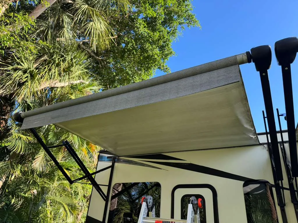 Roadwise RV technician replacing an RV awning at a Florida campground